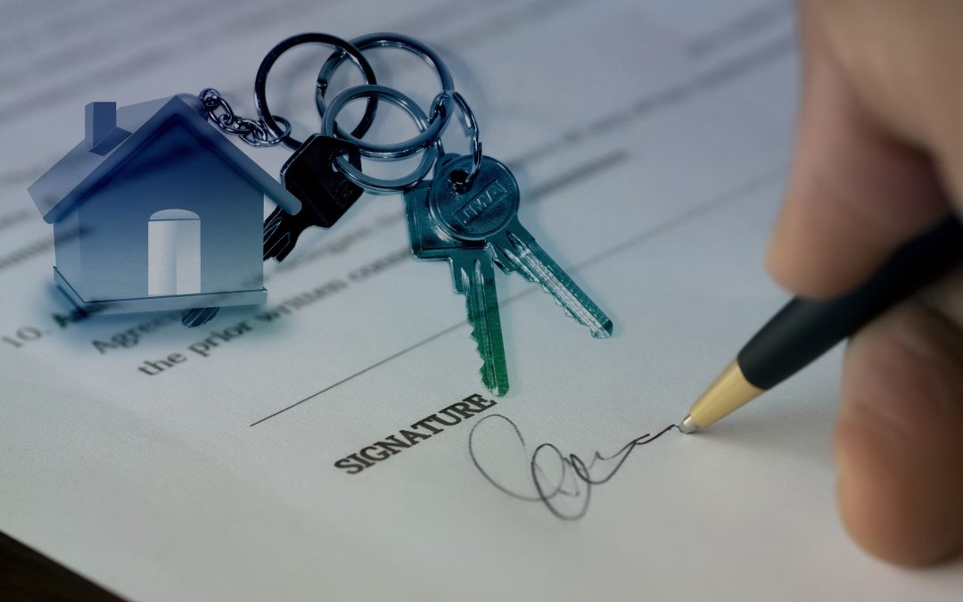 A close-up of a house keychain and a set of keys on top of a document with a signature line, symbolizing the home selling process.