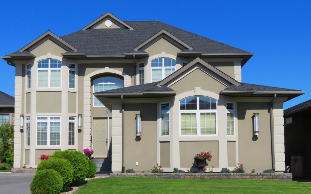 A beautiful home with excellent curb appeal, featuring well-maintained landscaping, a clean front yard, and decorative plants around the entrance.